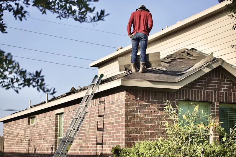Professional roofer working on a residential roof in Jordan Meadows